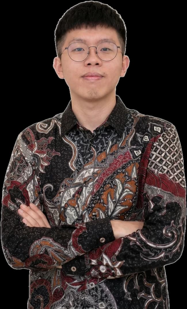 Abelito Visese, arms folded, in a batik shirt